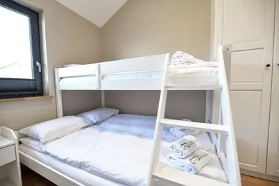 a bedroom with two bunk beds and a ladder at Sun & Garden View in Oświęcim
