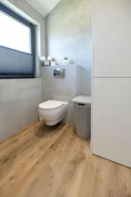 a bathroom with a toilet and a window at Sun & Garden View in Oświęcim