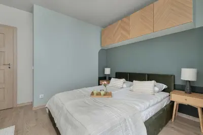 a bedroom with a large bed with a tray on it at Apartament z 2 Sypialniami Kraków Parking Blisko Tauron Arena by Noclegi Renters in Kraków