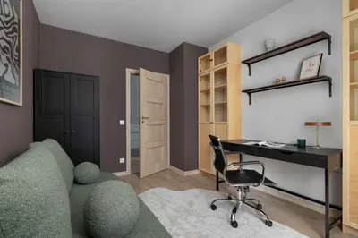 a room with a couch and a desk and a chair at Apartament z 2 Sypialniami Kraków Parking Blisko Tauron Arena by Noclegi Renters in Kraków