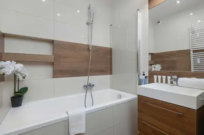 a bathroom with a tub and a sink and a shower at Apartament z 2 Sypialniami Kraków Parking Blisko Tauron Arena by Noclegi Renters in Kraków