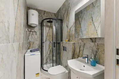a bathroom with a shower and a toilet and a sink at Langiewicza paradise in Kraków