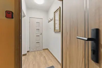 a door leading into a room with a wooden floor at Langiewicza paradise in Kraków