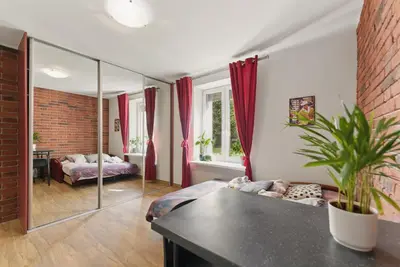 a living room with a bed and a mirror at Langiewicza paradise in Kraków