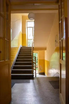 a staircase in a house with yellow walls at Langiewicza paradise in Kraków