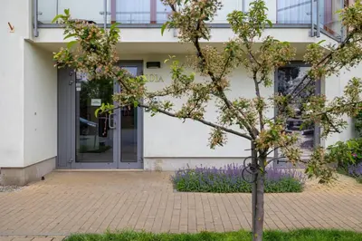 a tree in front of a building at Studio z Parkingiem i Balkonem w Krakowie by Rent like home in Kraków