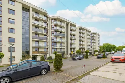 a parking lot with cars parked in front of a building at Studio z Parkingiem i Balkonem w Krakowie by Rent like home in Kraków