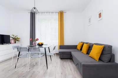 a living room with a couch and a table at Apartment Bosacka Cracow by Noclegi Renters in Kraków
