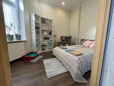 a bedroom with a bed and a chair in it at Traugutta 24 Przytulny Apartament z Biurkiem i Sypialnią by Noclegi Renters in Kraków