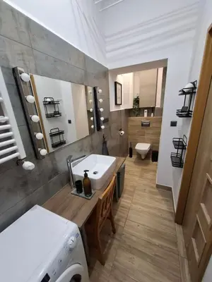 a bathroom with a white sink and a toilet at Traugutta 24 Przytulny Apartament z Biurkiem i Sypialnią by Noclegi Renters in Kraków