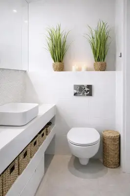 a bathroom with a toilet and a sink and two plants at Velour Apartment - Near ICE, Wawel Castle, Riverside and Old Town in Kraków