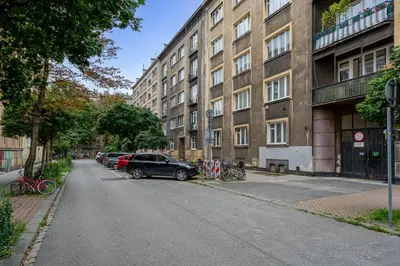 a street with cars parked in front of a building at Sereno Vista Apartment by BookingHost in Kraków
