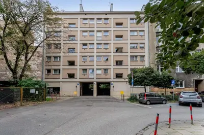 an empty parking lot in front of a building at Sereno Vista Apartment by BookingHost in Kraków
