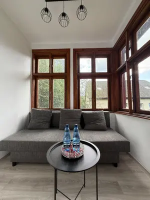a living room with a couch and a table at Parkowa Apartment in Wadowice