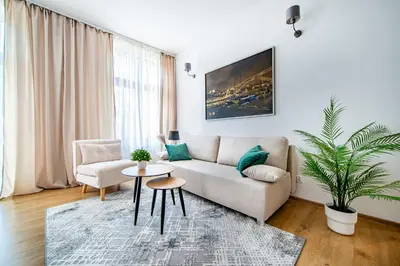 a living room with a couch and a table at Elegancki apartament - Kalwaryjska, centrum Krakowa in Kraków