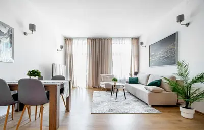 a living room with a couch and a table at Elegancki apartament - Kalwaryjska, centrum Krakowa in Kraków