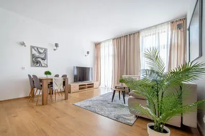 a living room with a couch and a table at Elegancki apartament - Kalwaryjska, centrum Krakowa in Kraków