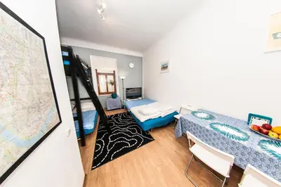 a room with a bed and a map on the wall at Homely Apartment's Old Town in Kraków