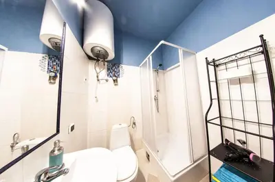 a bathroom with a toilet and a shower and a sink at Homely Apartment's Old Town in Kraków