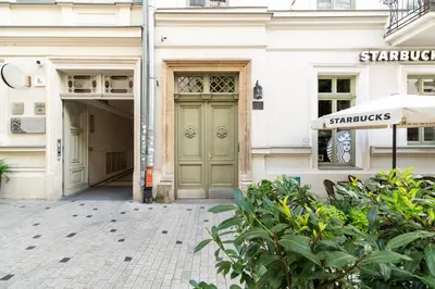 a building with a green door on a street at Old Town Krupnicza in Kraków