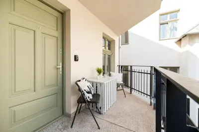 a hallway with a door and a table and chairs at Old Town Krupnicza in Kraków