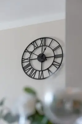 a clock hanging on a wall at High Apartment with a View of the Old Town by Noclegi Renters in Kraków