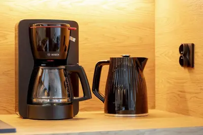 a black coffee maker sitting on top of a shelf at High Apartment with a View of the Old Town by Noclegi Renters in Kraków