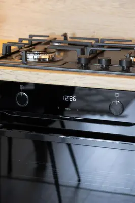 a stove top sitting on top of a microwave at High Apartment with a View of the Old Town by Noclegi Renters in Kraków
