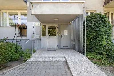 a walkway leading to a door of a house at High Apartment with a View of the Old Town by Noclegi Renters in Kraków