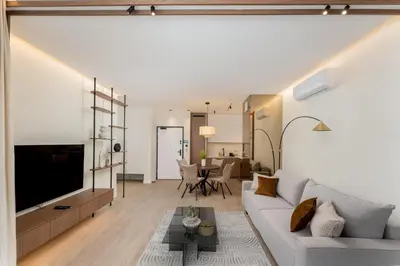 a living room with a couch and a table at Cracow Novum Apartments by BookingHost in Kraków