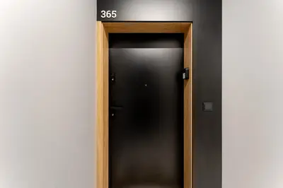 an elevator door with a sign on top of it at Cracow Novum Apartments by BookingHost in Kraków