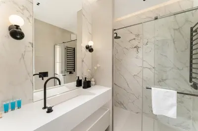 a bathroom with a sink and a shower at Cracow Novum Apartments by BookingHost in Kraków
