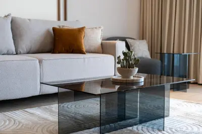 a living room with a couch and a glass coffee table at Cracow Novum Apartments by BookingHost in Kraków
