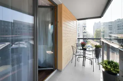 a balcony with a table and chairs on a balcony at Two-Bedroom Apartment with Living Room, Free Parking - Kazimierz in Kraków