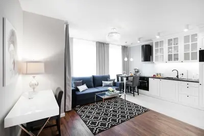 a living room with a blue couch and a kitchen at Two-Bedroom Apartment with Living Room, Free Parking - Kazimierz in Kraków