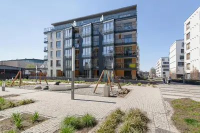 a playground in front of a large building at Two-Bedroom Apartment with Living Room, Free Parking - Kazimierz in Kraków