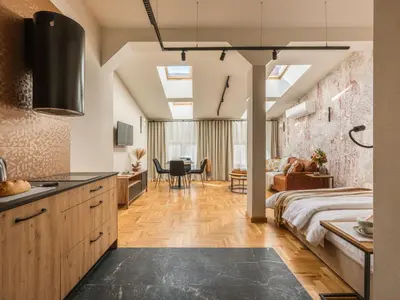 a bedroom with a bed and a table and chairs at Art Palace - Fragola Apartments in Kraków
