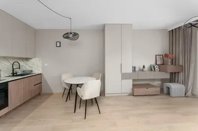 a kitchen with a table and chairs in a room at Walerego Sławka Harmony Apartment by BookingHost in Kraków