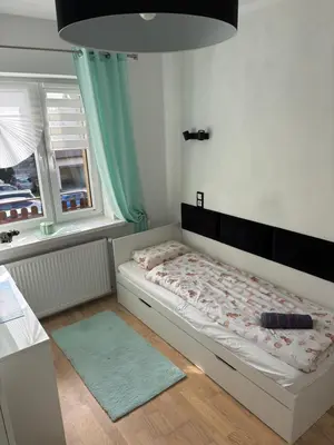 a bedroom with a bed in a room with a window at Smile Room Balice in Liszki