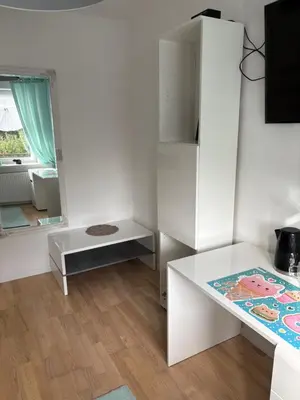 a white room with a table and a mirror at Smile Room Balice in Liszki