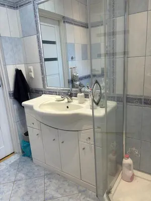 a bathroom with a sink and a shower at Smile Room Balice in Liszki