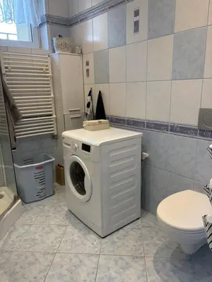 a washing machine in a bathroom with a toilet at Smile Room Balice in Liszki