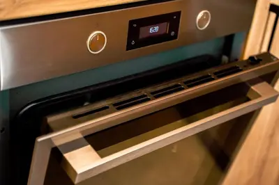 a microwave oven with its door open in a kitchen at Domki Natura Zator in Graboszyce