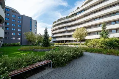 a park in front of a large building at Kaskada in Kraków