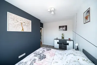 a bedroom with a bed and a desk at Kaskada in Kraków