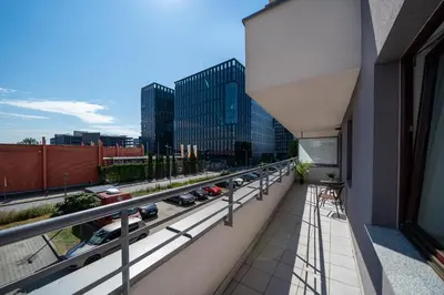 a balcony of a building with cars on a highway at Kaskada in Kraków