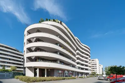 a large white building with people on top of it at Kaskada in Kraków