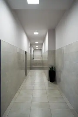 a hallway of a building with a tile floor at Kaskada in Kraków