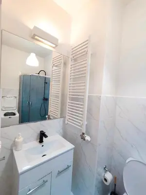 a white bathroom with a sink and a toilet at Krakow City Stay Vintage in Kraków