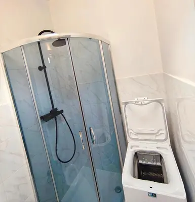 a bathroom with a shower with a sink at Krakow City Stay Vintage in Kraków